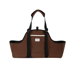 Front view of the brown Baguette dog carrier with black straps and a zipped front pocket.