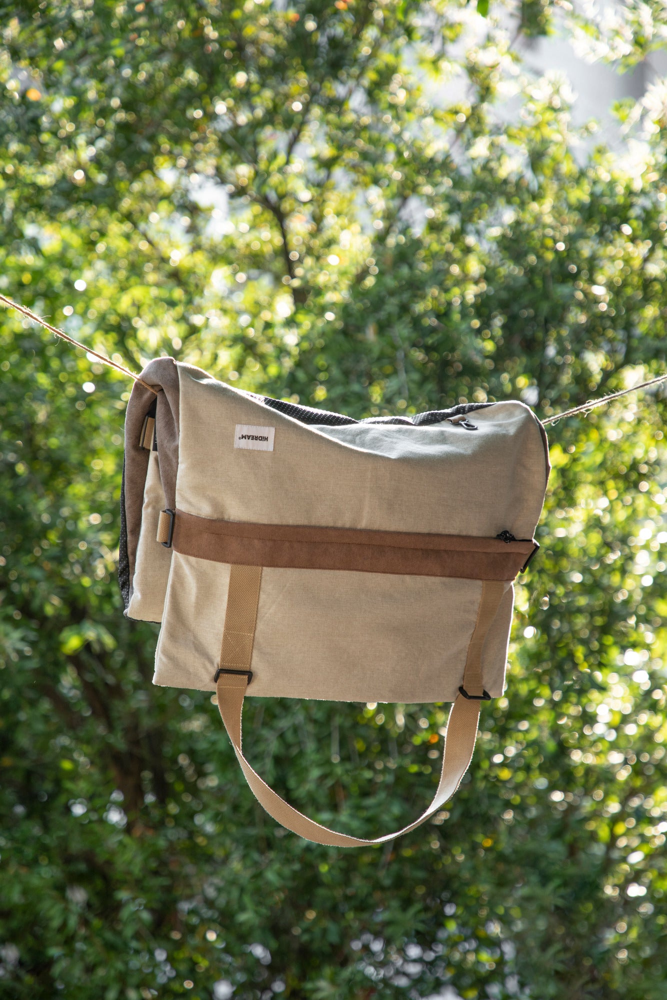 Removable brown and cream pet-bed cover hanging on a line after cleaning.